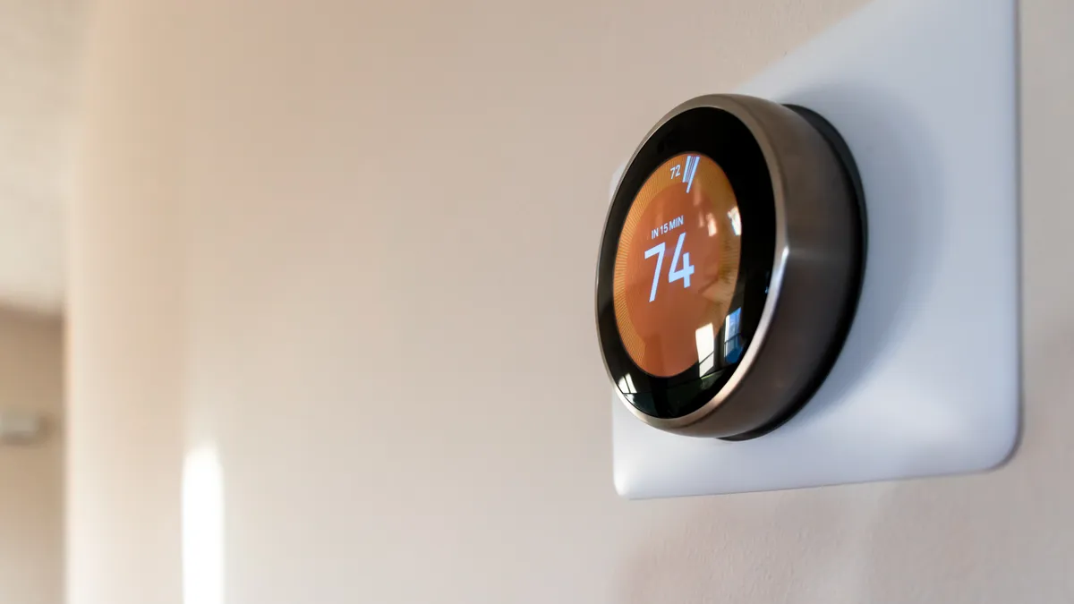 A "smart" thermostat on a wall.