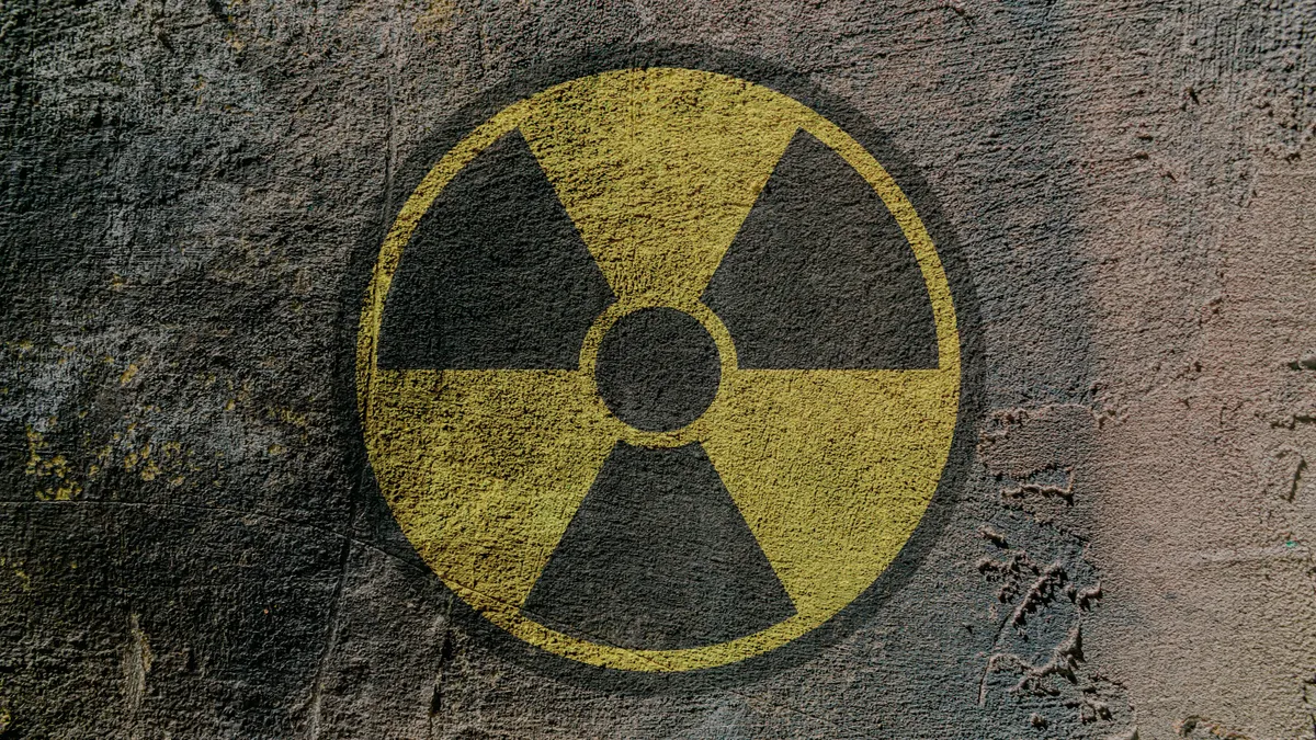 Radiation hazard warning sign depicted on a concrete wall