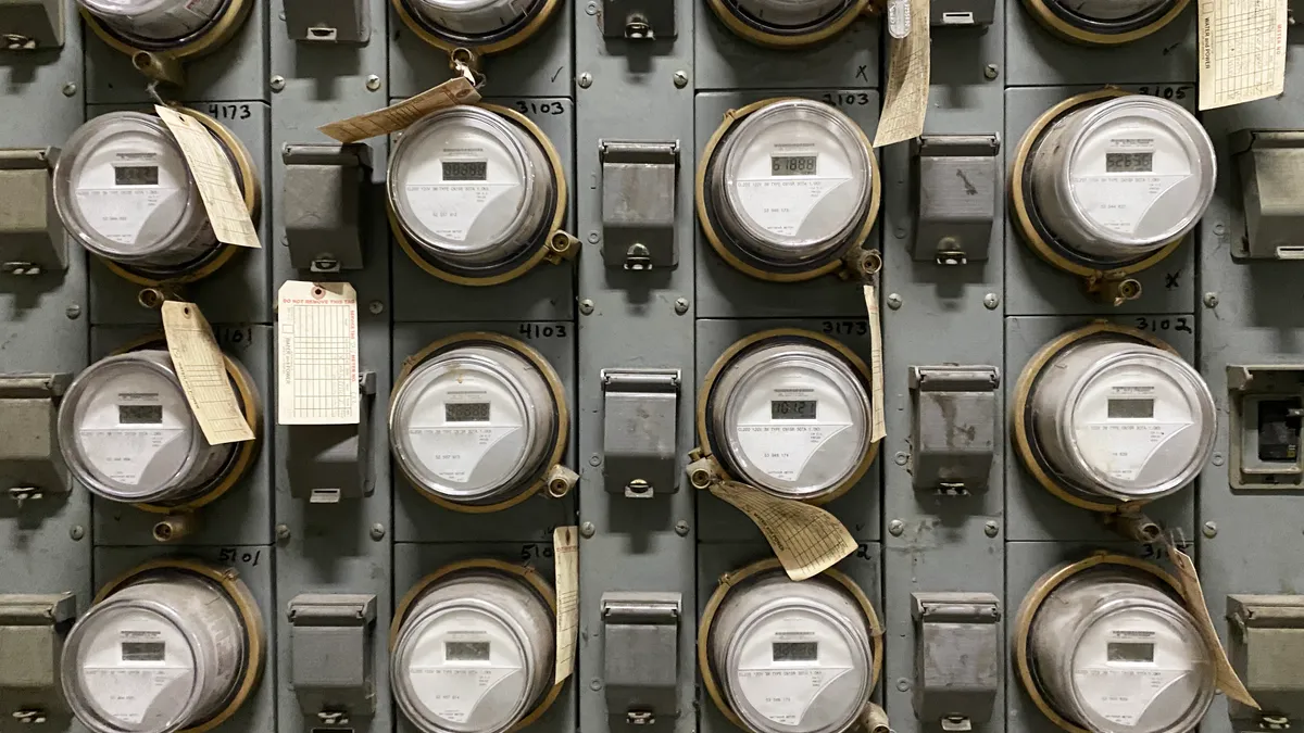 A bank of electricity meters on a wall.