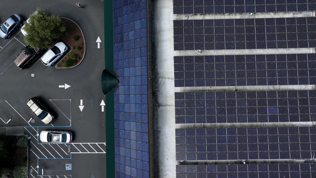 In an aerial view, solar panels are seen on the roof of Woodlands Market on April 25, 2024 in Kentfield, California.