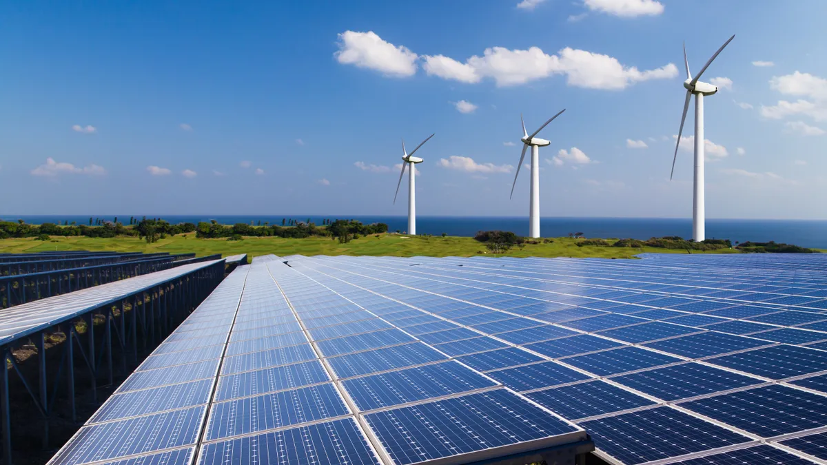 Solar panels and wind turbines in a field