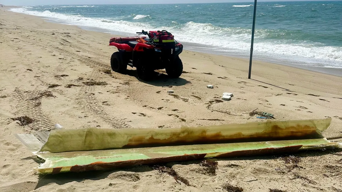 Debris from the broken Vineyard Wind turbine blade lies on a beach in Nantucket.